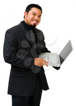 Businessman using a laptop and smiling isolated over white