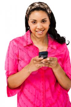 Portrait of a woman text messaging on a mobile phone isolated over white