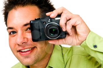 Caucasian man photographing with a camera and smiling isolated over white