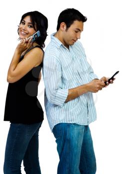Portrait of a couple using mobile phones isolated over white