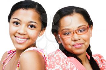 Close-up of two teenage girls smiling isolated over white