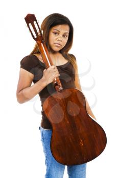 Pre adolescent girl holding a guitar isolated over white