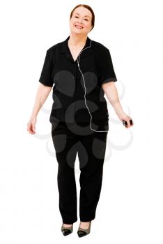 Caucasian woman listening to MP3 player isolated over white