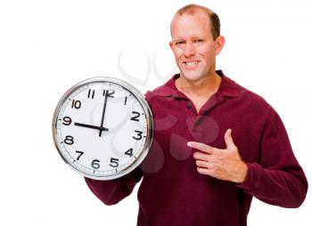 Smiling mature man showing a clock isolated over white