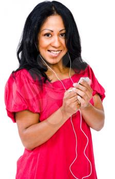 Mid adult woman listening to music on MP3 player isolated over white