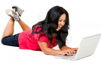 Mid adult woman using a laptop and smiling isolated over white