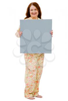 Confident mature woman showing a placard isolated over white