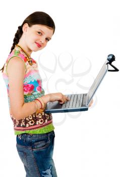 Happy girl using a laptop and posing isolated over white