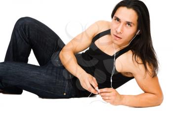 Portrait of a young man listening to MP3 player isolated over white