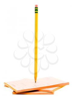 Pencil with a stack of notepads isolated over white