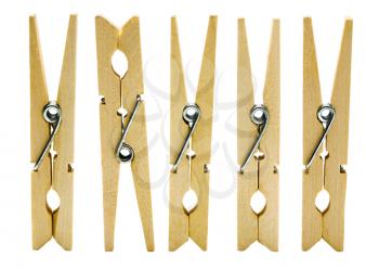 Close-up of wooden clothespins in a row isolated over white