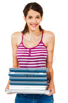Confident woman holding a stack of laptops isolated over white