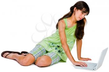 Teenage girl using a laptop and posing isolated over white
