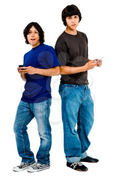 Men text messaging on mobile phones and smiling isolated over white