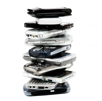 Assorted mobile phones in a stack isolated over white
