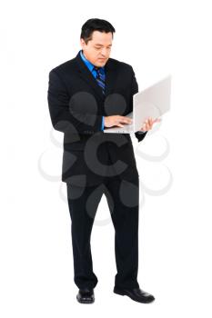 Mid adult businessman working on a laptop isolated over white