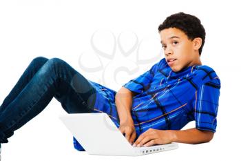 Teenage boy surfing the net isolated over white