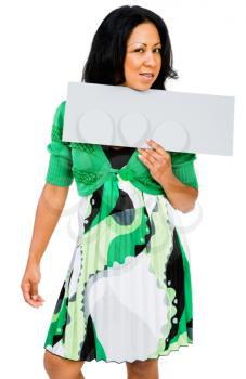 Confident woman showing a placard and posing isolated over white