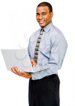 Happy businessman using a laptop and posing isolated over white