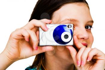 Cute girl holding a camera and photographing isolated over white
