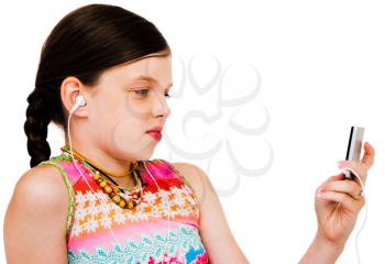 Child listening to music on MP3 player isolated over white