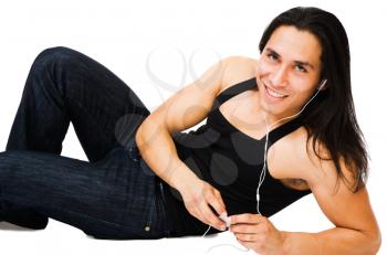 Man listening to MP3 player and smiling isolated over white