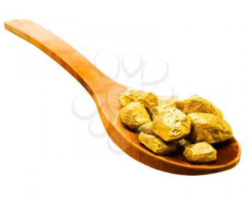 Gold pieces in a wooden spoon isolated over white