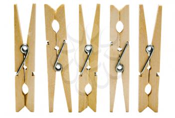 Five wooden clothespins in a row isolated over white