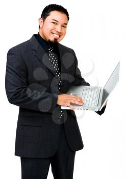 Portrait of a businessman using a laptop and smiling isolated over white
