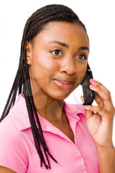 Teenage girl talking on a mobile phone and smiling isolated over white