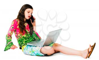 Girl using a laptop and a mobile phone isolated over white
