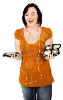 Smiling woman listening to music on an media player isolated over white