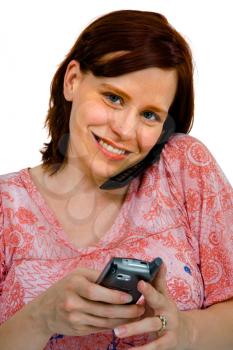 Smiling woman using mobile phones isolated over white