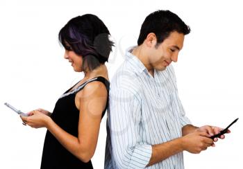 Young couple text messaging on mobile phones isolated over white