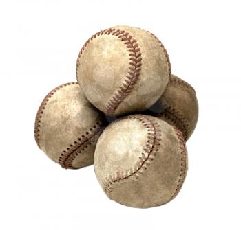 Four dirty baseballs isolated over white
