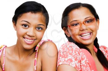 Close-up of two teenage girls smiling isolated over white