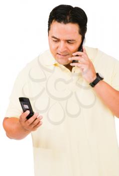 Mid adult man using a mobile phone isolated over white