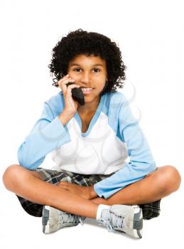 Boy using a mobile phone isolated over white