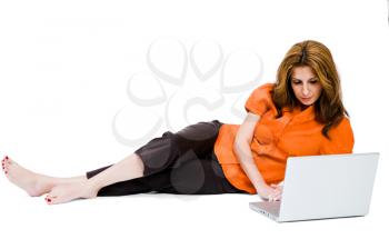 Mid adult woman using a laptop and posing isolated over white