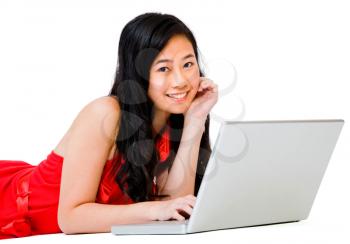 Portrait of a woman using a laptop and smiling isolated over white