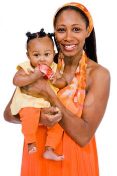 Mid adult woman carrying her daughter and smiling isolated over white