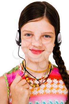 Close-up of a girl listening to music on headphones isolated over white