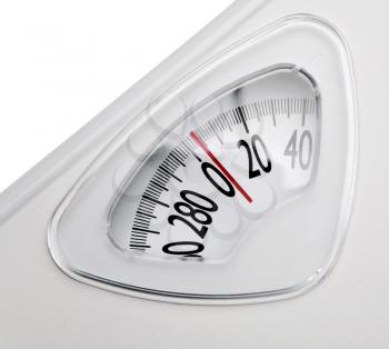 Close-up of a weighing scale isolated over white
