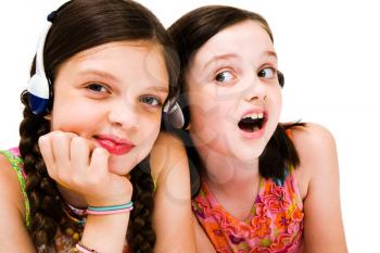 Portrait of girls listening to music on headphones isolated over white