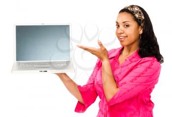 Smiling young woman showing a laptop isolated over white