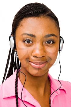 Portrait of a teenage girl listening to music on headphones isolated over white