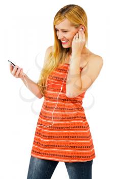 Fashion model listening to music on MP3 player isolated over white
