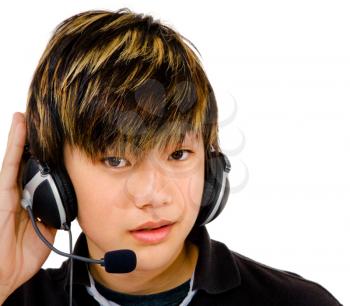 Asian teenage boy wearing headphones and listening to music isolated over white