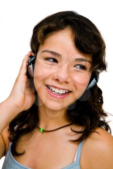 Happy teenage girl listening to music on a headphones isolated over white