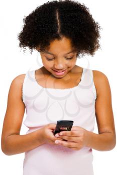 Girl text messaging with a mobile phone isolated over white